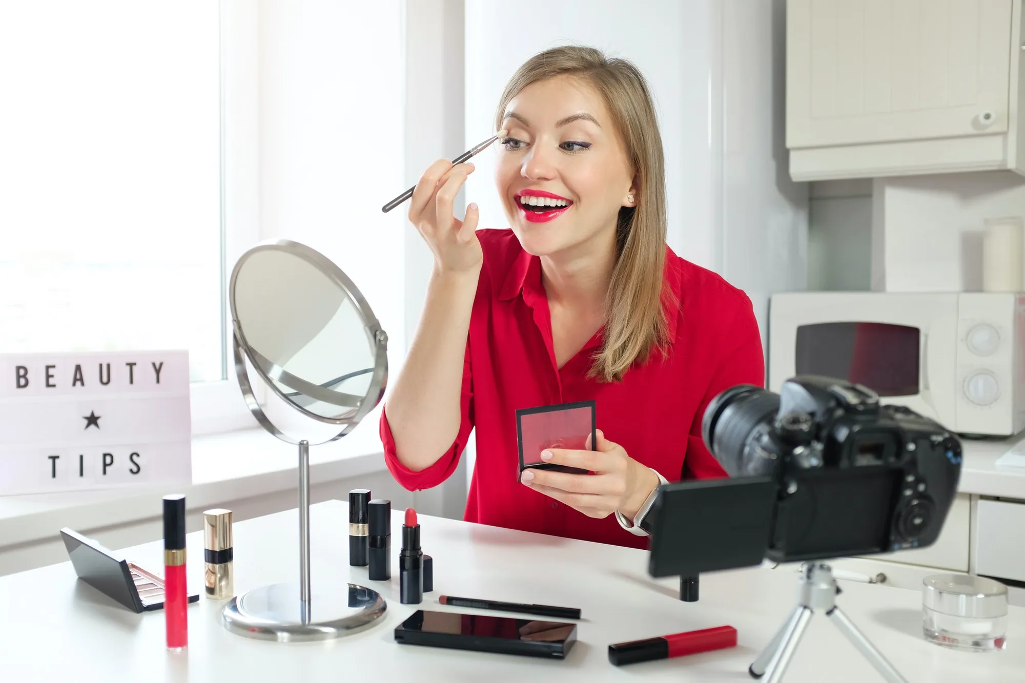 stylish-young-woman-blogger-recording-make-up-video-guide-on-beauty-tips